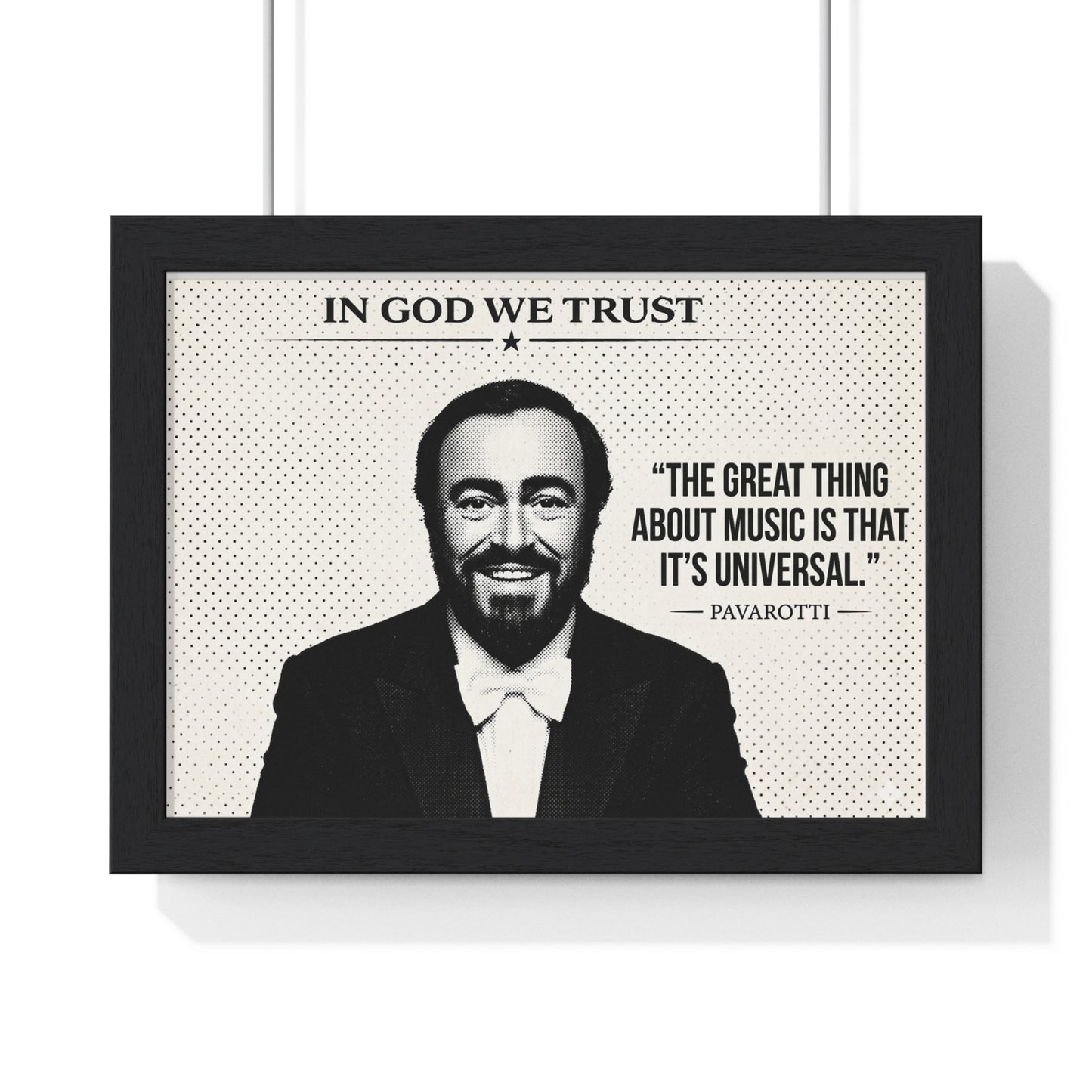 Framed poster with a portrait of a man and a quote, featuring the text 'In God We Trust' and 'The great thing about music is that it's universal. Pavarotti'.