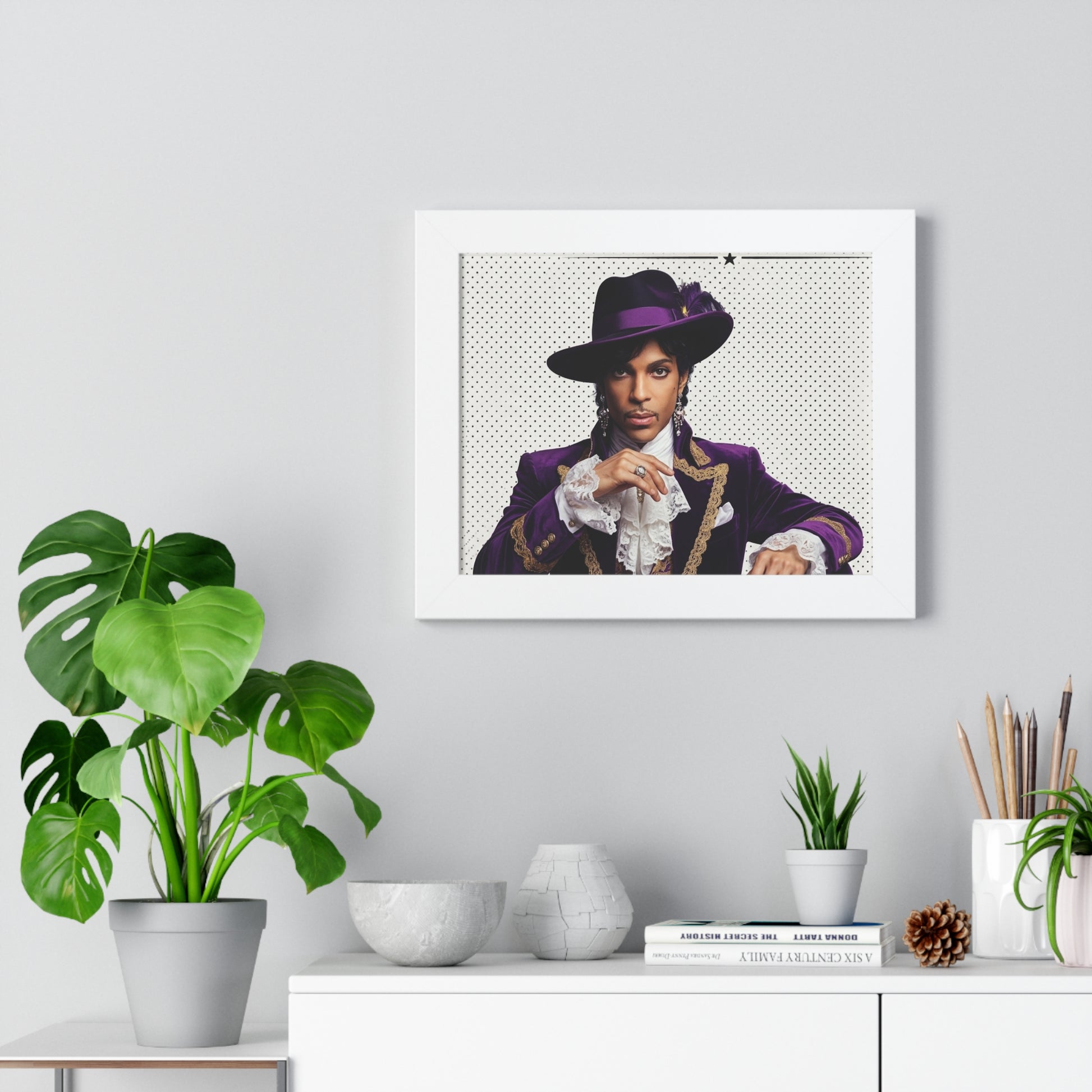 Framed portrait of a person in a purple outfit on a wall above a white cabinet with decorative items.
