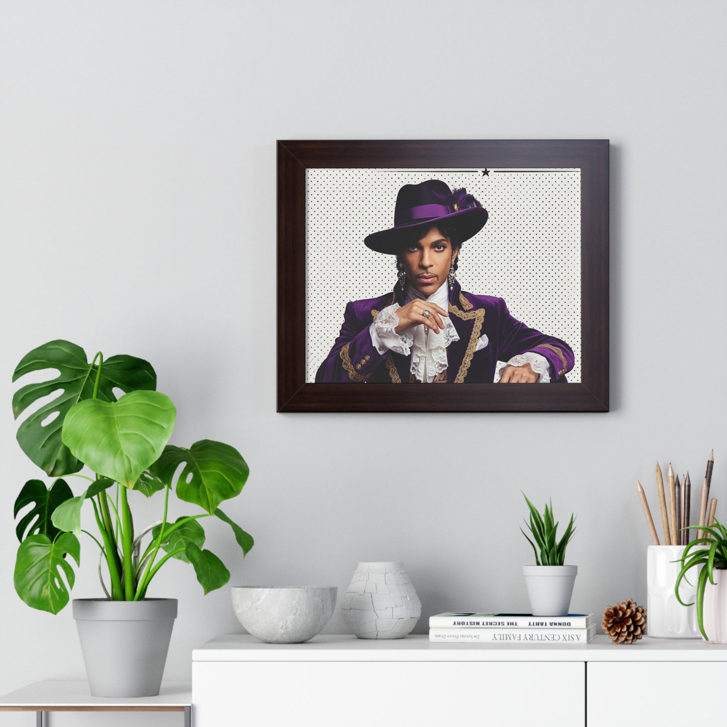Framed portrait of a person in a purple outfit on a wall above a white cabinet with decorative items.