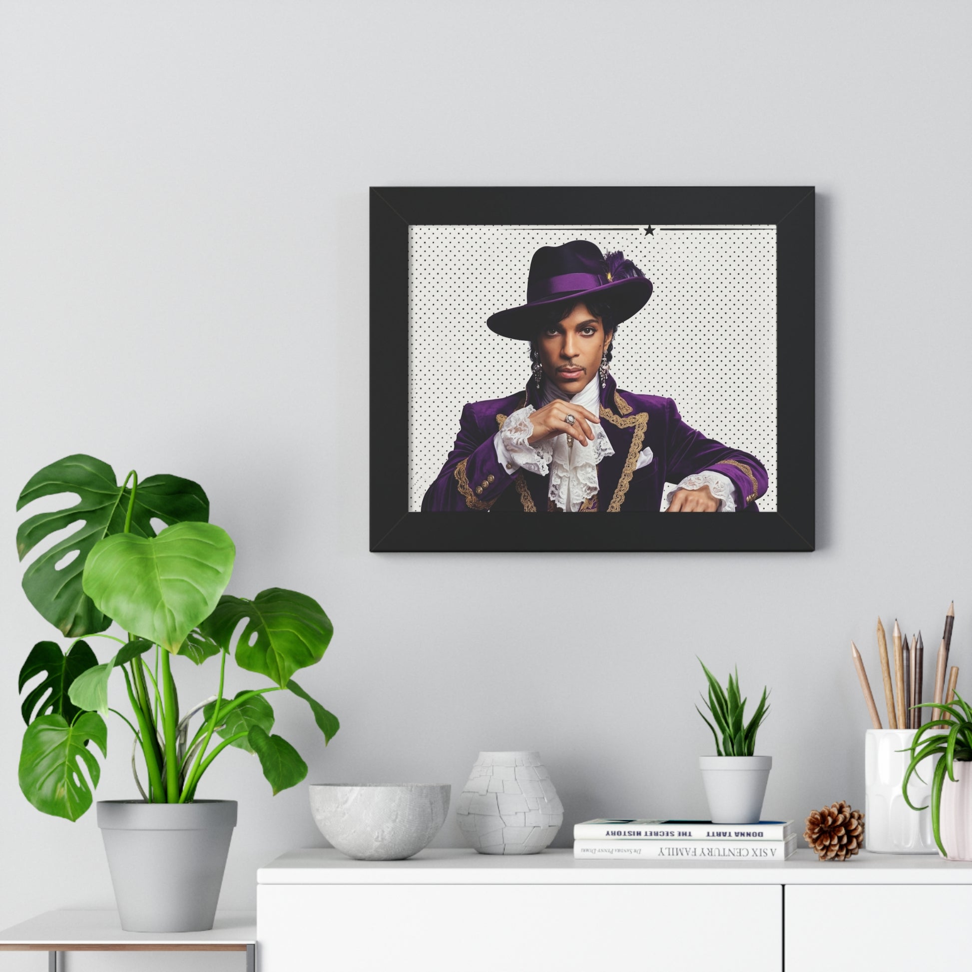 Framed portrait of a person in a purple outfit on a wall above a white cabinet with decorative items.