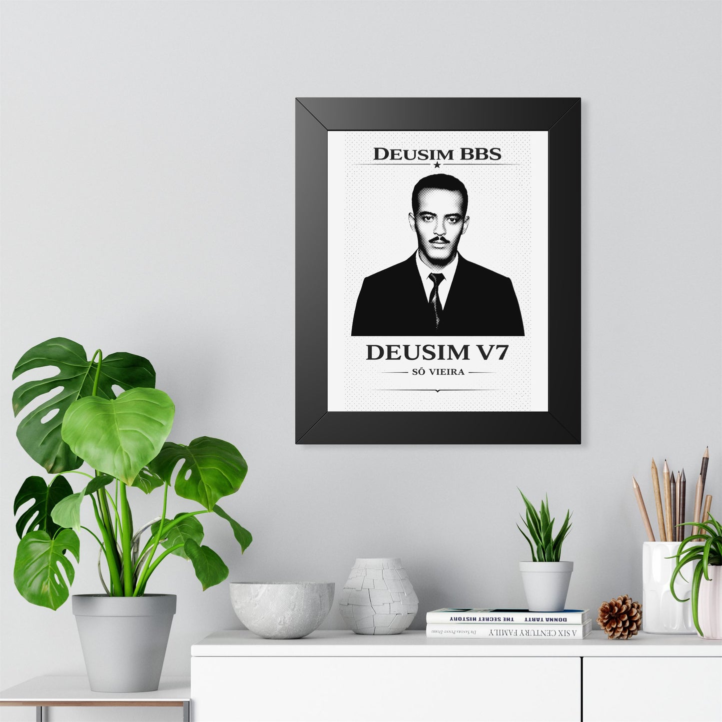 Framed ART of a man in a suit on a wall with decorative plants and items below.