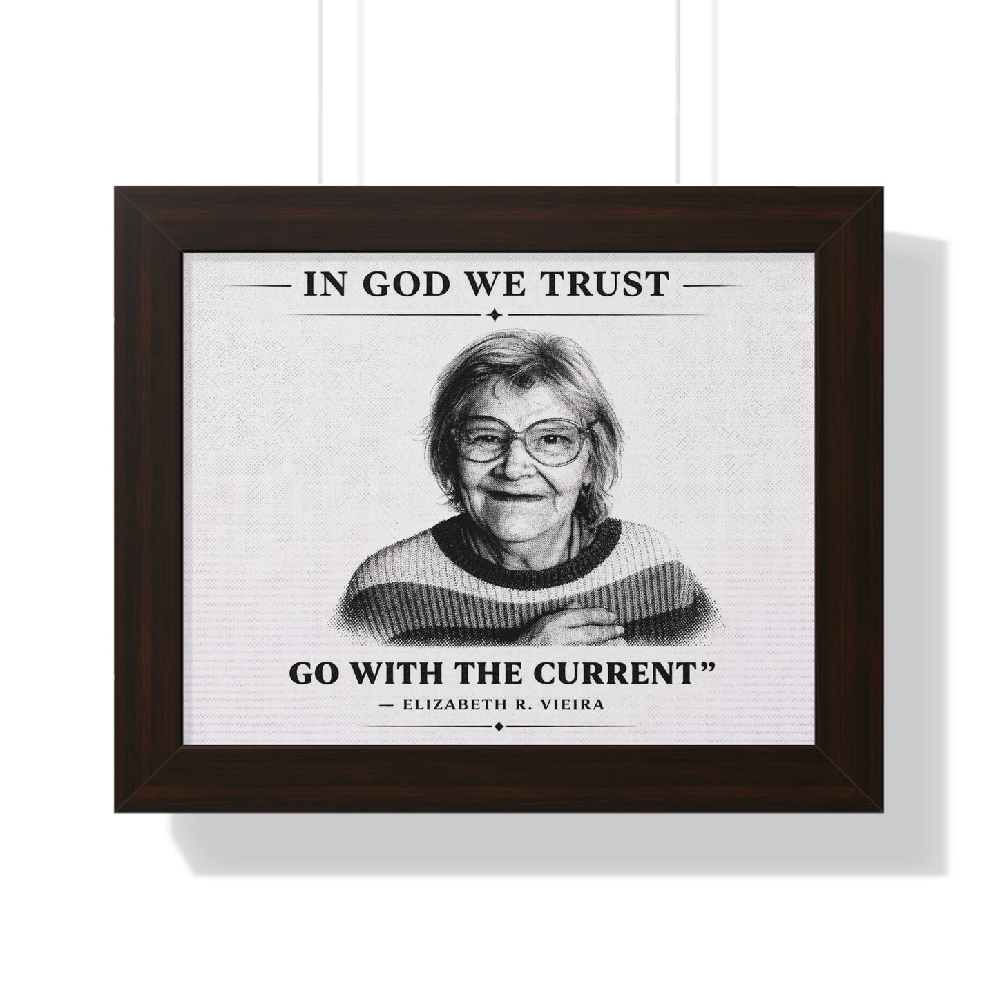 Framed print with a portrait of a woman and text 'In God We Trust, Go with the Current' by Elizabeth R. Vieira on a white background.