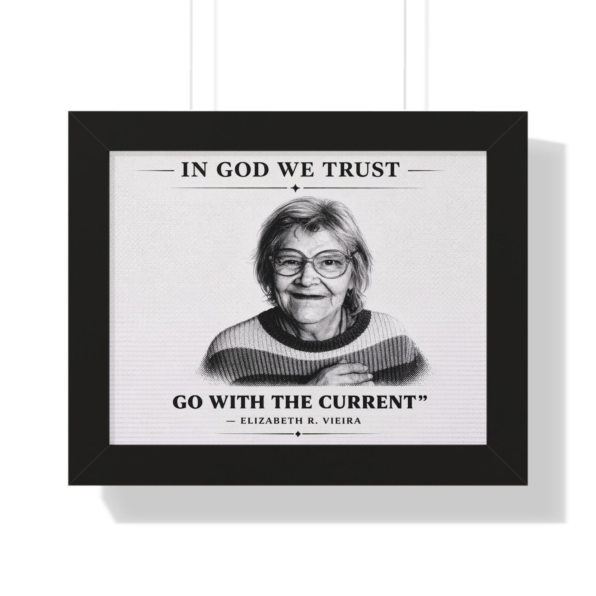 Framed print with a black and white portrait of a woman and text 'In God We Trust, Go with the Current - Elizabeth R. Vieira' on a white background.